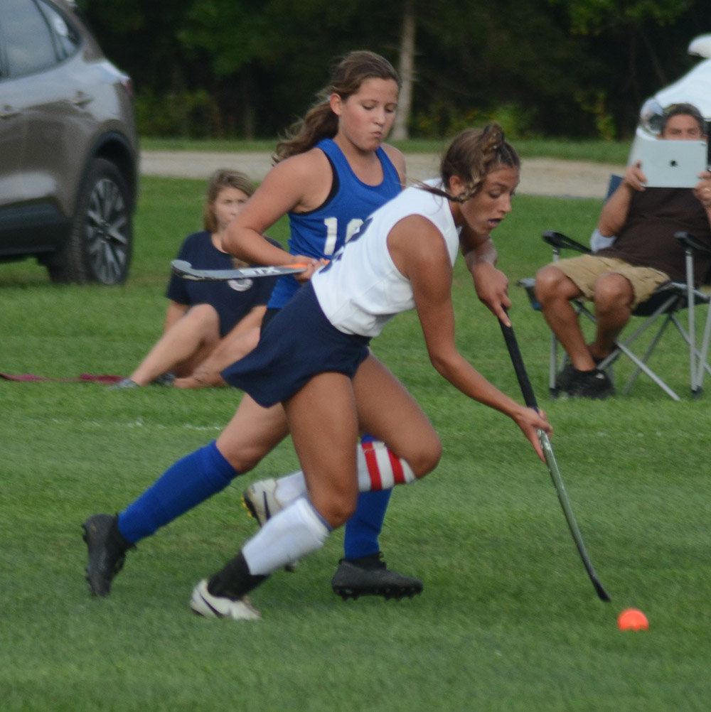 Pine Bush’s Jennifer Sorrentino brings the ball down the field as Coxsackie-Athens’ Addison Chimento pursues during Wednesday’s non-league field hockey game at Pine Bush Elementary School.